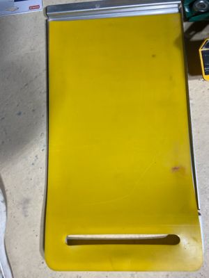 a yellow piece of paper sitting on a table next to a pair of scissors