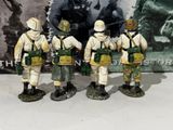 four figurines of soldiers standing next to each other