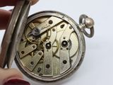 a close up of a pocket watch being held by a person