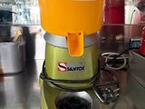 a juicer sitting on a counter with a price tag on it