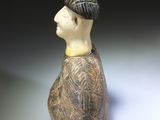 a ceramic figurine of a man with a hat on his head