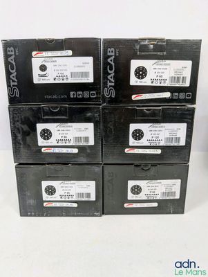 four boxes of black electronic devices are stacked on top of each other
