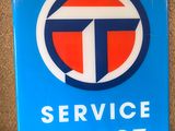 une enseigne bleue « Service Talbot » posée sur un comptoir, à côté d'un téléphone