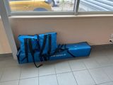 a blue bag sitting on the floor next to a window