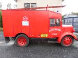 a red truck parked in front of a building
