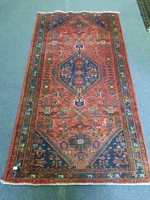 a red and blue rug on a blue floor