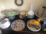 many plates and vases sitting on a table