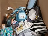 a cardboard box filled with baby items and a stuffed animal