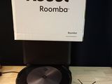 a robot that is sitting on a table next to a box