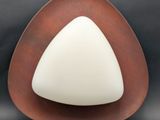 a white and brown triangle shaped object on a black background
