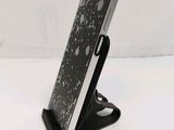 a cell phone that is on a stand on a table