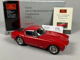 the red car is next to a boxed box of books