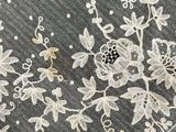 a close up of a piece of lace with flowers on it