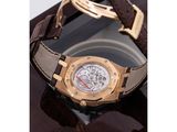 an image of a gold watch with a brown leather strap