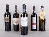 several bottles of wine are lined up on a table