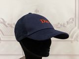 the hat is blue with orange lettering on it and a black mannequin head