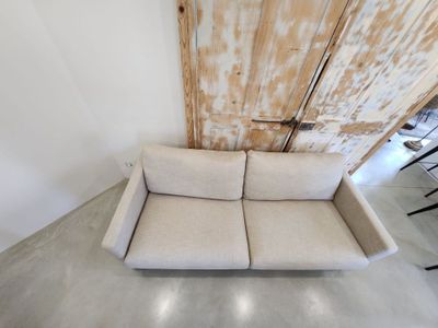 a couch that is sitting in front of a wooden door
