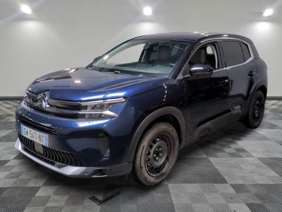 un 4x4 bleu garé dans un garage au sol en damier