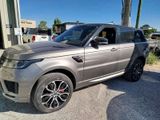 a picture of a silver land rover parked in front of a building