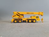 a yellow toy truck with a crane on the back