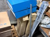 a blue box sitting on top of a pallet in a warehouse