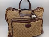 Sac de voyage en toile et cuir « guccissi gg »