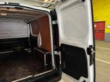 a white van with the door open in a garage