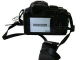 a camera with a strap attached to it ' s body