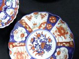 three plates with different designs on them on a black surface