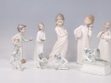 five figurines of children and a dog on a table