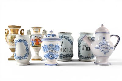 many vases that are lined up on a white surface