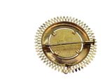 a gold brooch with a star design on it