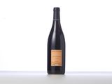 a bottle of wine sitting on top of a white table