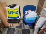 two chairs in a room with boxes and boxes on the floor