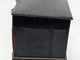 an antique black and gold box with a drawer on top