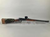 a rifle with a wooden barrel on a clear stand
