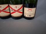 three bottles of wine sitting on top of a table next to each other