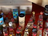 many bottles of alcohol sitting on a table next to a wooden box