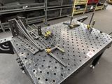 many pieces of metal sitting on a table in a warehouse