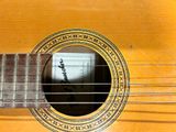 a close up of a guitar with a small hole in the neck