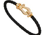 a black leather bracelet with a gold clasp and a diamond clasp