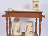 a small wooden table with two vases on it