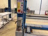 an image of a machine in a factory with tables and benches