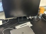 a desk with a laptop and a monitor on it