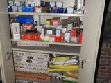 a cupboard full of boxes and other items in a room