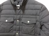 the jacket is black and has buttons on the chest