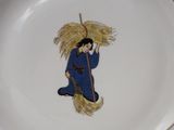 a plate with a picture of a man with a broom on it