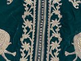 an image of a close up of a green jacket with birds on it