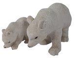 two polar bears standing next to each other on a white surface