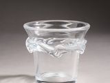 a small glass vase with a leaf design on it